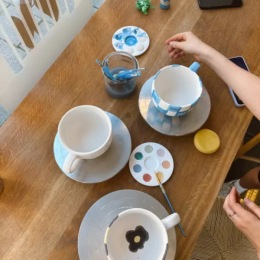 a table with paint supplies next to a window
