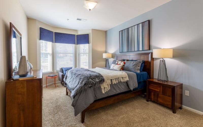 a bedroom with a bed and a desk